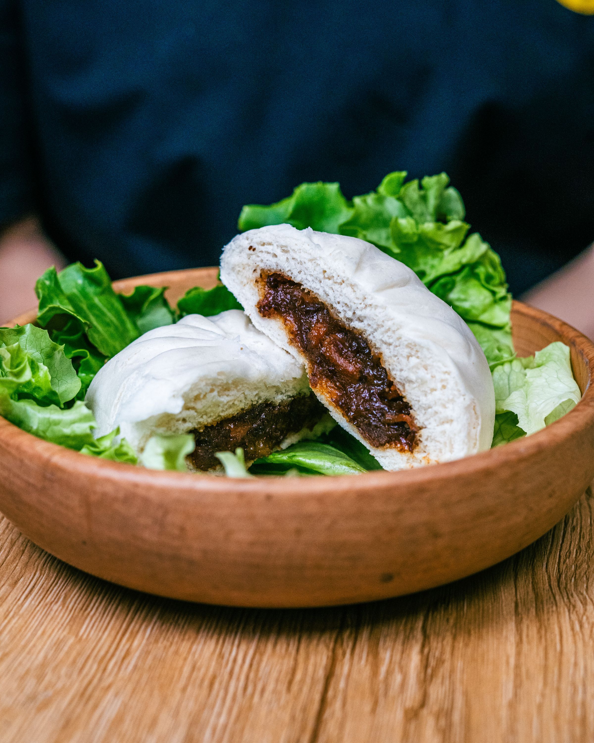 Pain bao garni, servi avec de la salade verte, dans un restaurant asiatique spécialisé en street food vietnamienne.